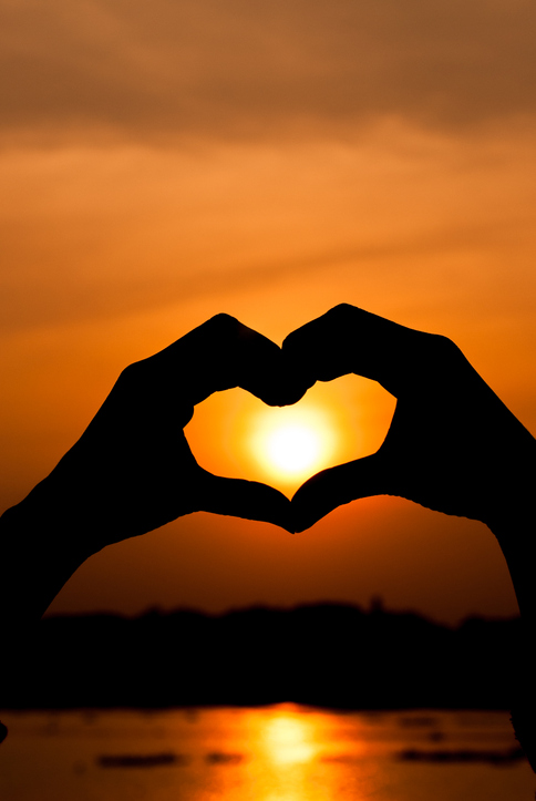 heart hand silhouette at sunset